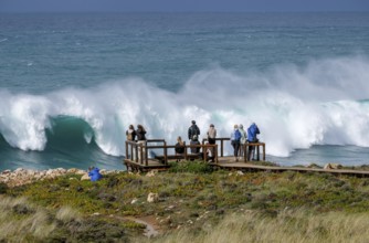 Carrapateira, Algarve, Portugal - Tourists on a viewing platform marvel at the roaring surf and