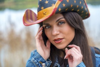 Close-up portrait of a sensual woman wearing a brimmed american hat