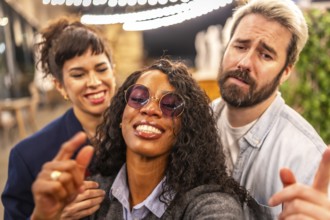 Close-up and personal point of view of multi-ethnic friends pulling funny faces while taking selfie