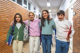 Group of cheerful students walking together in school hallway with arms around each other