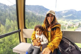Tourists enjoying a scenic cable car ride in the italian dolomites, taking in the breathtaking