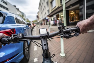 Cycling in the city, inner-city street, cycle lane, bicycles have priority, two-lane traffic with