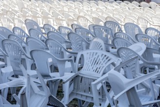 Seating for outdoor event, rows of chairs, overturned garden chairs made of plastic, plastic,