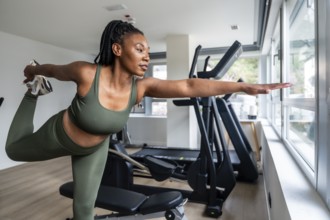 Manager stretching legs in hotel fitness room during business trip, maintaining healthy lifestyle