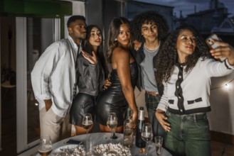 Beauty chic woman and multi-ethnic friends taking selfie with cellphone during night roof party