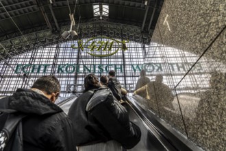 Cologne Central Station, escalators to and from the platform, passengers waiting for the train,