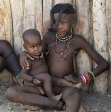 Himba girl with forward braided plaits with baby, near Opuwo, Kaokoveld, Kunene, Namibia, Africa