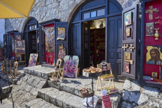 An art shop with icons and paintings displayed on a stone staircase, Chora, Patmos main town,