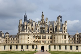 Close-up of a magnificent castle with detailed decorations and high towers under a slightly cloudy