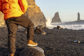 Unrecognizable person on the beautiful Reynisfjara Black Sand Beach in Iceland in winter