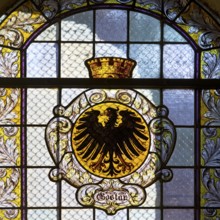 Stained glass window with the city coat of arms in the market church of St Cosmas and Damian,