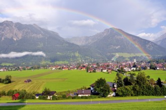 View over Oberstdorf with rainbow, behind it the Schattenberg with Schattenbergschanze, Oberallgäu,
