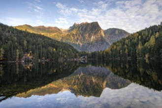 Mountain peaks of the Ötztal Alps reflected in Lake Piburger See, in autumn, near Ötz in Ötztal,