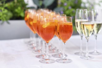 Glasses with orange colored Spritz, a wine-based cocktail drink on table in restaurant at wedding