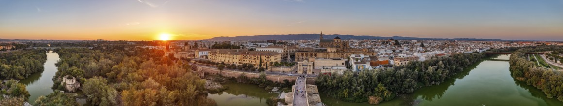 Panoramic view of a city at sunset with river and bridge in the foreground, Cordoba