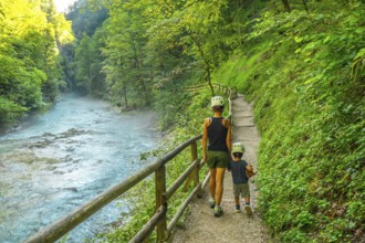 Tourists enjoying a scenic walk through the beautiful vintgar gorge near bled, slovenia, on a