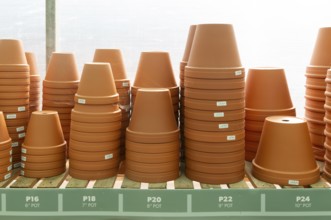 Variety of sizes of clay flower pots on display in at Swanns Nursery garden centre, Suffolk,