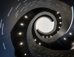 Spiral staircase printed with Finnish words, Oodi Central Library and Cultural Centre, designed by