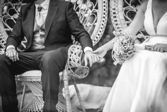 Newlywed couple holding hands, celebrating their love and commitment on their wedding day
