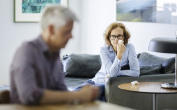 Symbolic photo on the subject of problems in a partnership. An older woman and an older man sitting