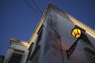 Lantern, street lamp, shines on house wall, old town, Faro, dusk, evening light, Algarve, Portugal,