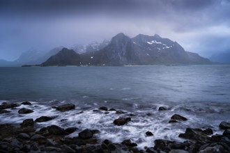 Landscape with sea and mountains on the Lofoten Islands, view across the fjord to the small town of