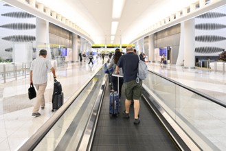 Airport transit tourists with luggage, Abu Dhabi, UAE