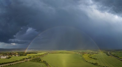 Thunderstorm cell with rainbow over fields near Krebs in the Osterzgebirge, Krebs, Saxony, Germany,