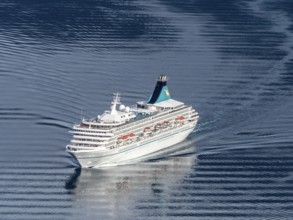 Cruise ship Artania leaving the Geirangerfjord into fjord Synnylvsfjord, seen from viewpoint at