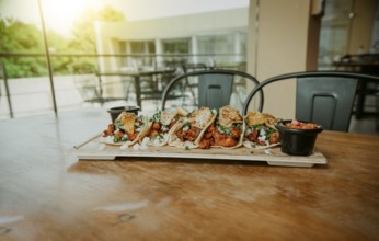 Delicious Mexican chicken tacos with sauces served on table restaurant. Traditional tacos al pastor