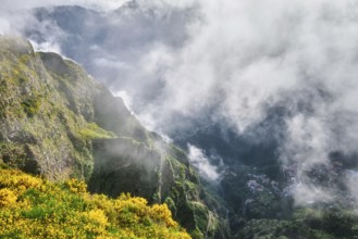 Aerial drone view of Curral das Freiras village from Miradouros do Paredao with blooming yellow