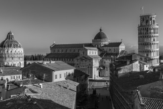 Above the roofs of Pisa, behind the Baptistery, the Cathedral of Santa Maria Assunta and the