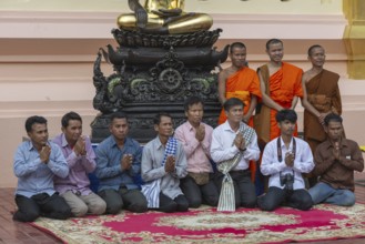 Monks and Laotians in front of a Buddha statue, Bhumispara-mudra, Buddha Gautama at the moment of