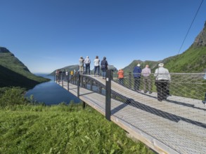 Tourist group visits viewing platform at Bergsbotn, viewpoint over fjord Bergsfjorden, Senja