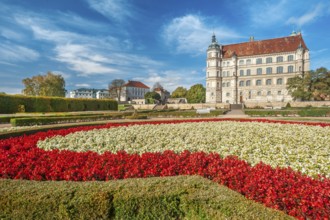 Güstrow Castle in autumn with colourful flower beds, built in the 16th century, Renaissance