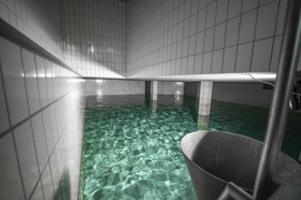 Large water basin with tiled walls and reflecting water, ENCW Netze Calw waterworks, Calw, Black