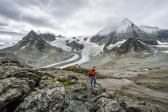 Mountaineer in front of impressive mountain landscape, mountain hut Cabane des Dix in front of