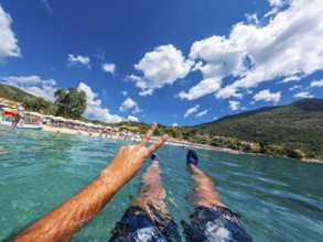 Resting in the sea on the beach in summer of Paralia Mikros Gialos in the south of the island of