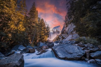 Sunset at Vernal Falls in Yosemite National Park in the water next to the stones, long exposure