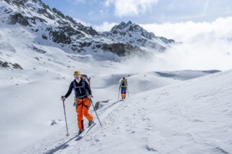 Ski tourers on the Bündner Haute Route, Albula Alps in winter, Rhaetian Alps, Graubünden, Eastern
