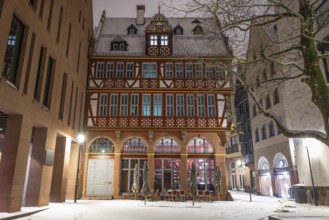 Snow lies in front of the Golden Scales, the most elaborately restored building in Frankfurt's New
