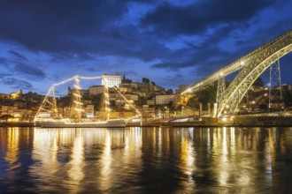 View of Porto city and Douro river with sailing ship from famous tourist viewpoint Marginal de Gaia