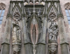 Sculptures to the left and right of the main entrance portal of St Nicholas and St Ulrich Church,