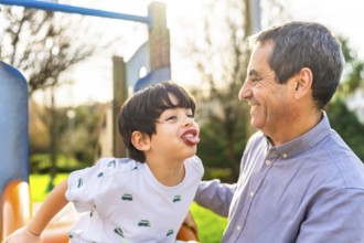 Grandfather and grandson having fun together at the playground, enjoying quality time and creating