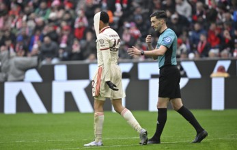 Jamal Musiala FC Bayern Munich FCB (42) disappointed pulls jersey over head Referee Florian