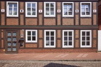 Façade with door and windows of a half-timbered house in Stade, Hanseatic city, district of Stade,