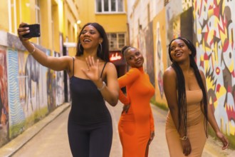 San Sebastián, Gipuzkoa Spain, February 2021: Three girls taking a selfie. Fashionable urban style