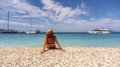 Portrait of a tourist woman resting on the Gidaki Beach on the island of Ithaki or Ithaca in the