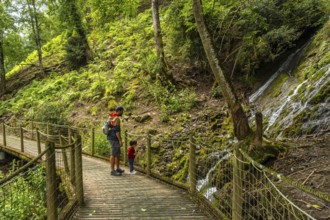 Father and son on a mountain trail in the Borce commune of the French Pyrenees