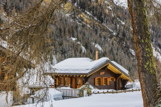 Snow-covered wooden chalet, winter landscape, mountain village Zinal, Val d'Anniviers, Valais Alps,
